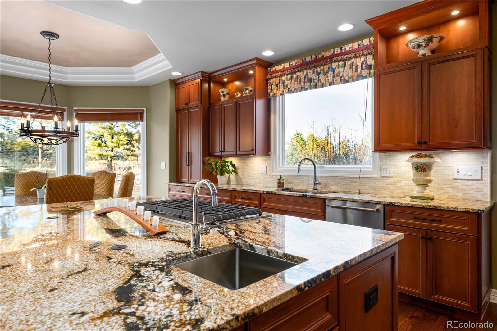 71 North Ranch Road Littleton, CO 80127 - Photo 15 of 40 a kitchen with stainless steel appliances granite countertop a sink a stove and a wooden cabinets