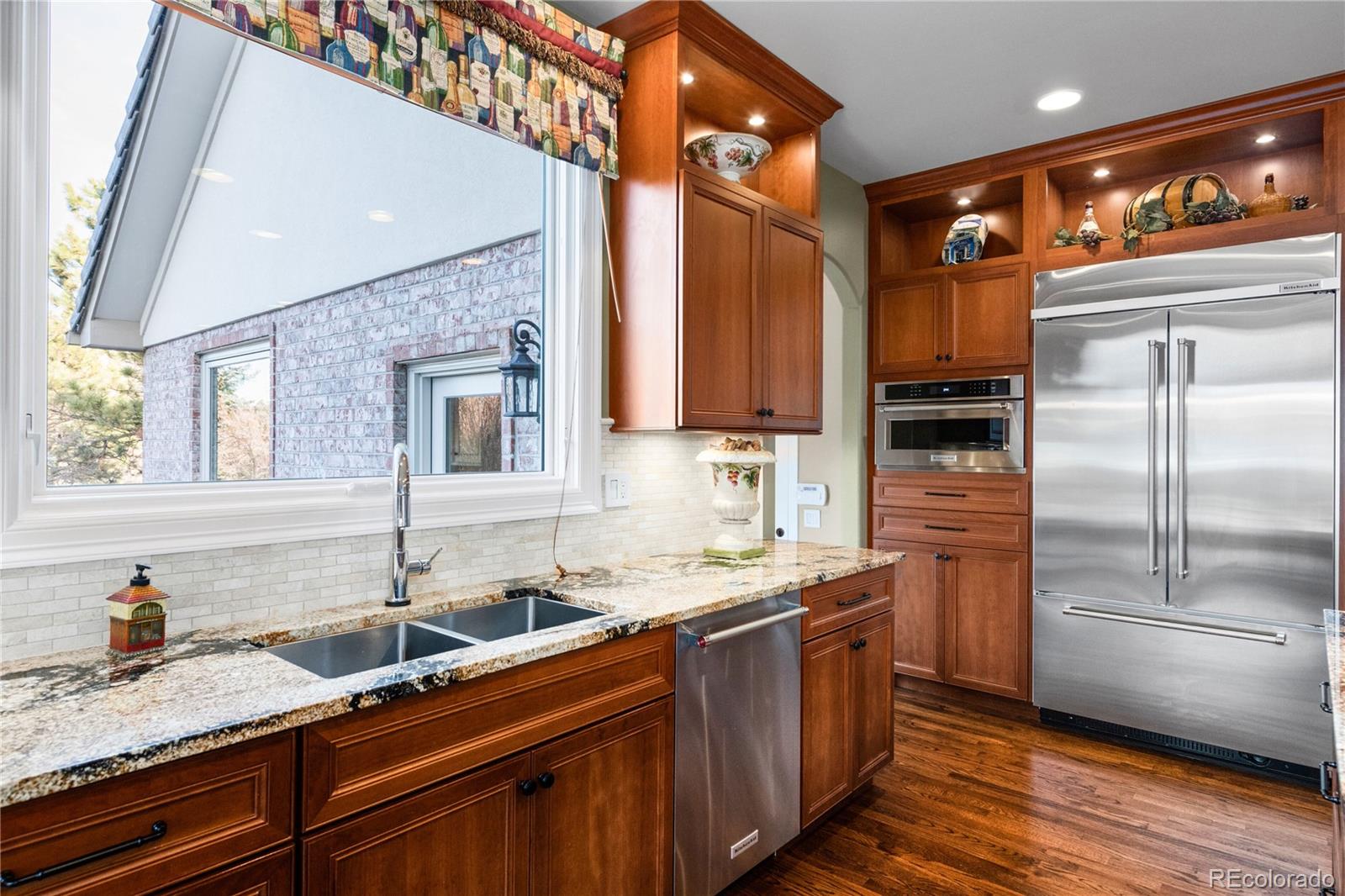 71 North Ranch Road Littleton, CO 80127 - Photo 16 of 40 a kitchen with stainless steel appliances granite countertop a sink stove and refrigerator