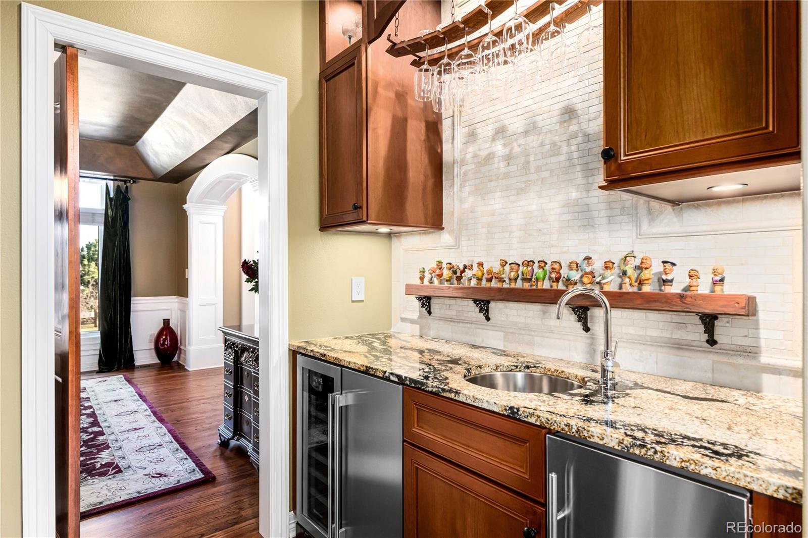 71 North Ranch Road Littleton, CO 80127 - Photo 17 of 40 a kitchen with a sink and a refrigerator