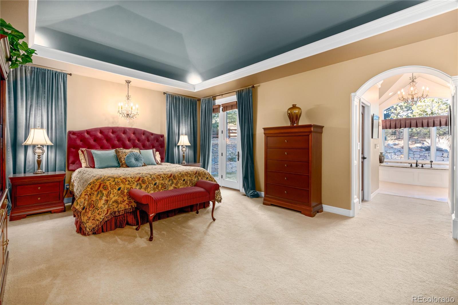 71 North Ranch Road Littleton, CO 80127 - Photo 20 of 40 a spacious bedroom with a bed and a dresser next to a window