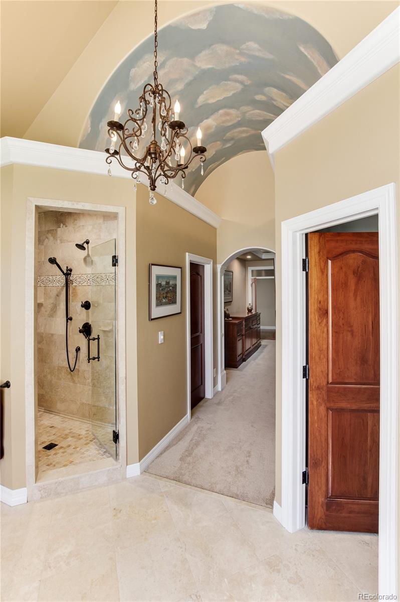 71 North Ranch Road Littleton, CO 80127 - Photo 23 of 40 a view of a hallway with a chandelier fan and livingroom view