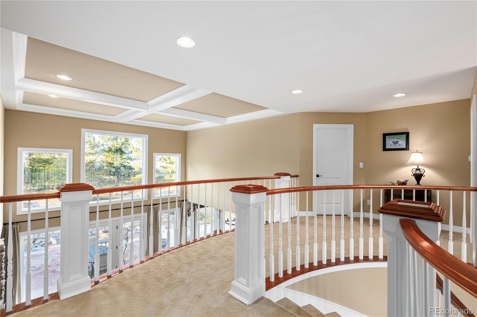 71 North Ranch Road Littleton, CO 80127 - Photo 26 of 40 a view of a hallway with windows