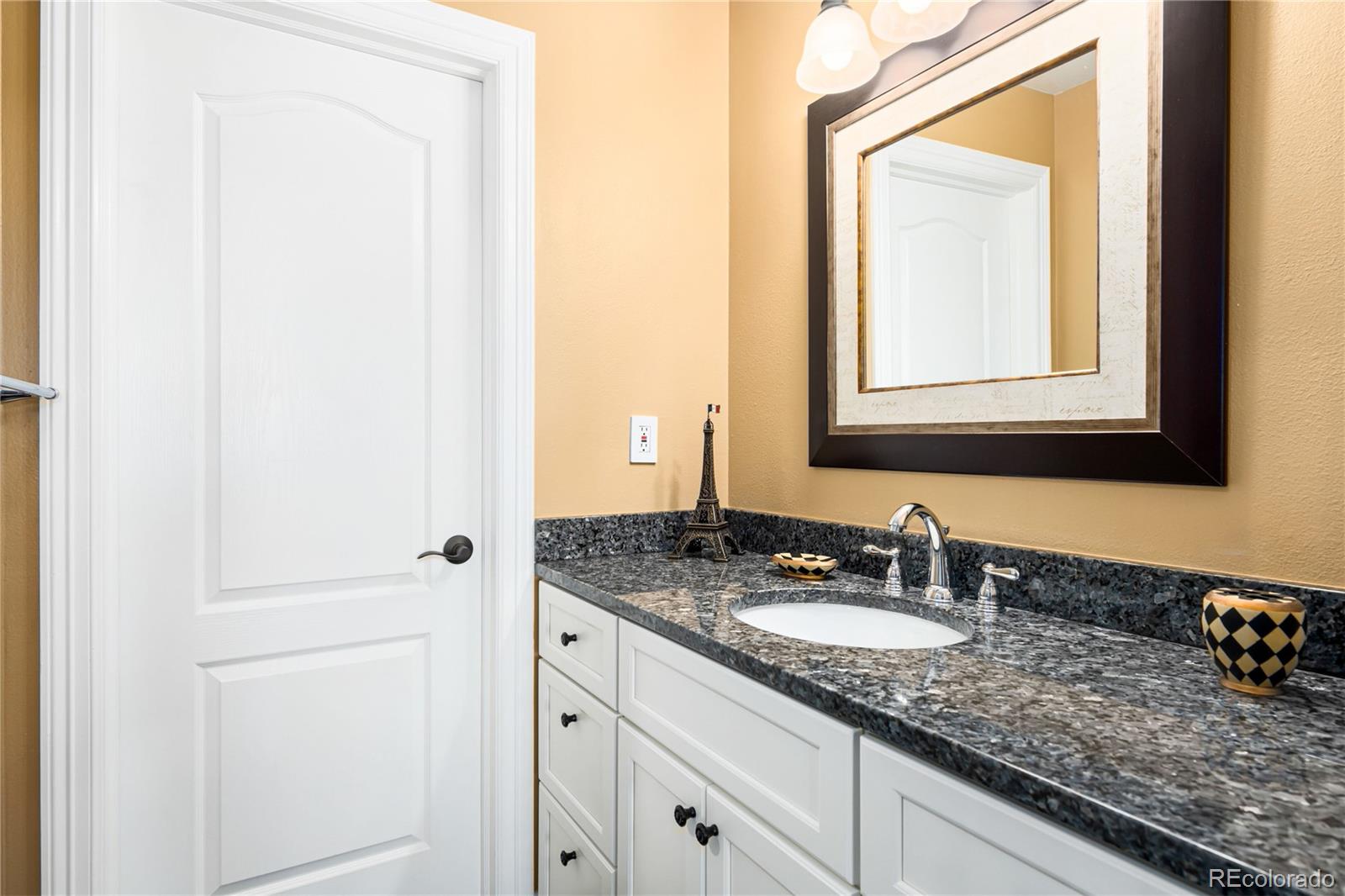71 North Ranch Road Littleton, CO 80127 - Photo 27 of 40 a bathroom with a granite countertop sink and a mirror