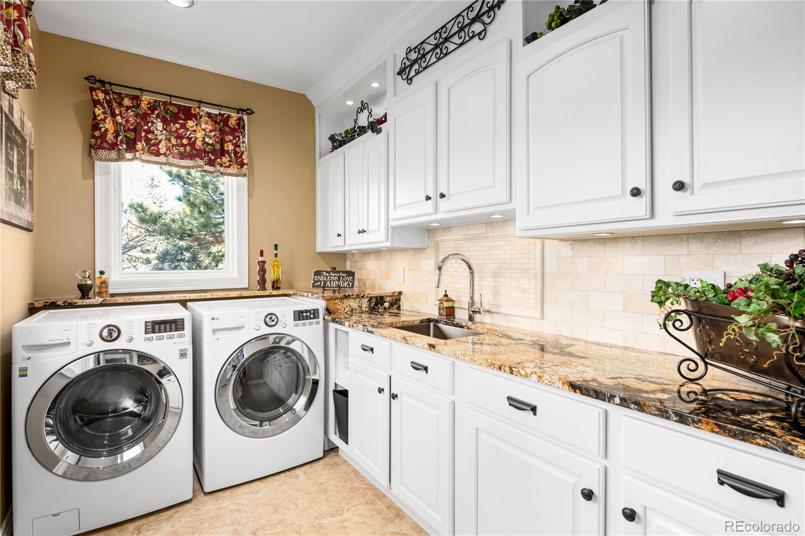 71 North Ranch Road Littleton, CO 80127 - Photo 29 of 40 a utility room with granite countertop a sink a washer and dryer next to a window