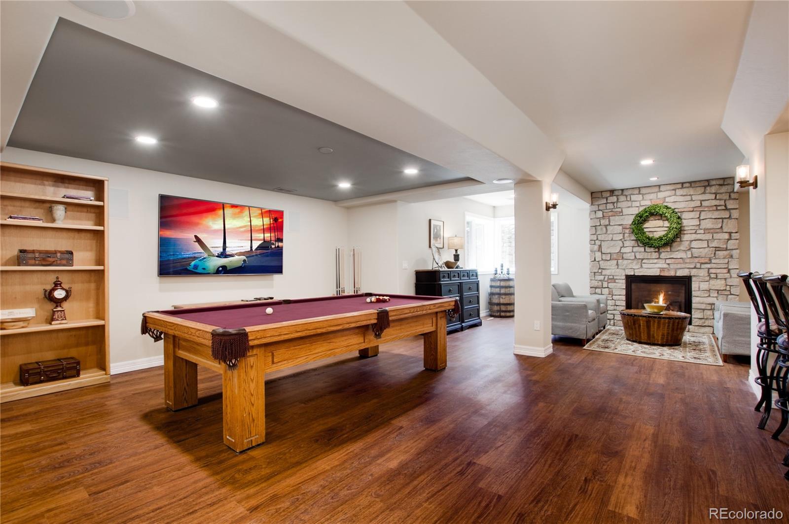 71 North Ranch Road Littleton, CO 80127 - Photo 31 of 40 a living room with furniture a flat screen tv and a fireplace