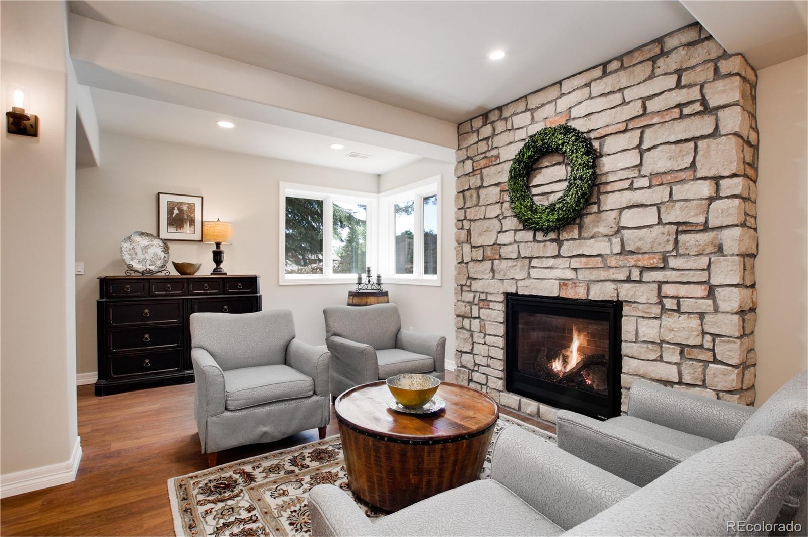71 North Ranch Road Littleton, CO 80127 - Photo 32 of 40 a living room with furniture a flat screen tv and a fireplace