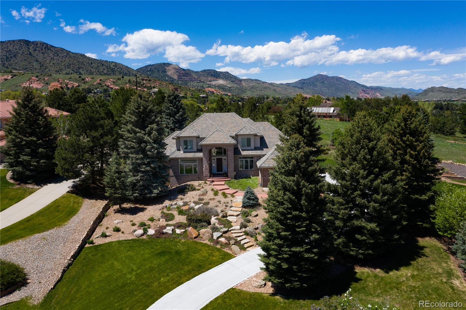 71 North Ranch Road Littleton, CO 80127 - Photo 38 of 40 a view of a house with a yard and garden