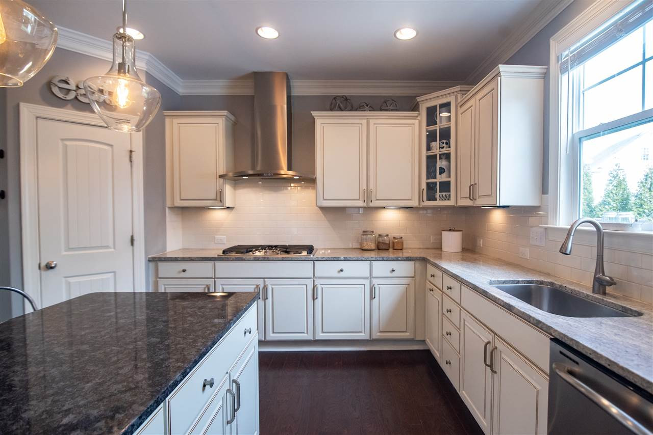 Chef's kitchen features gas range and stainless steel hood! Kitchen