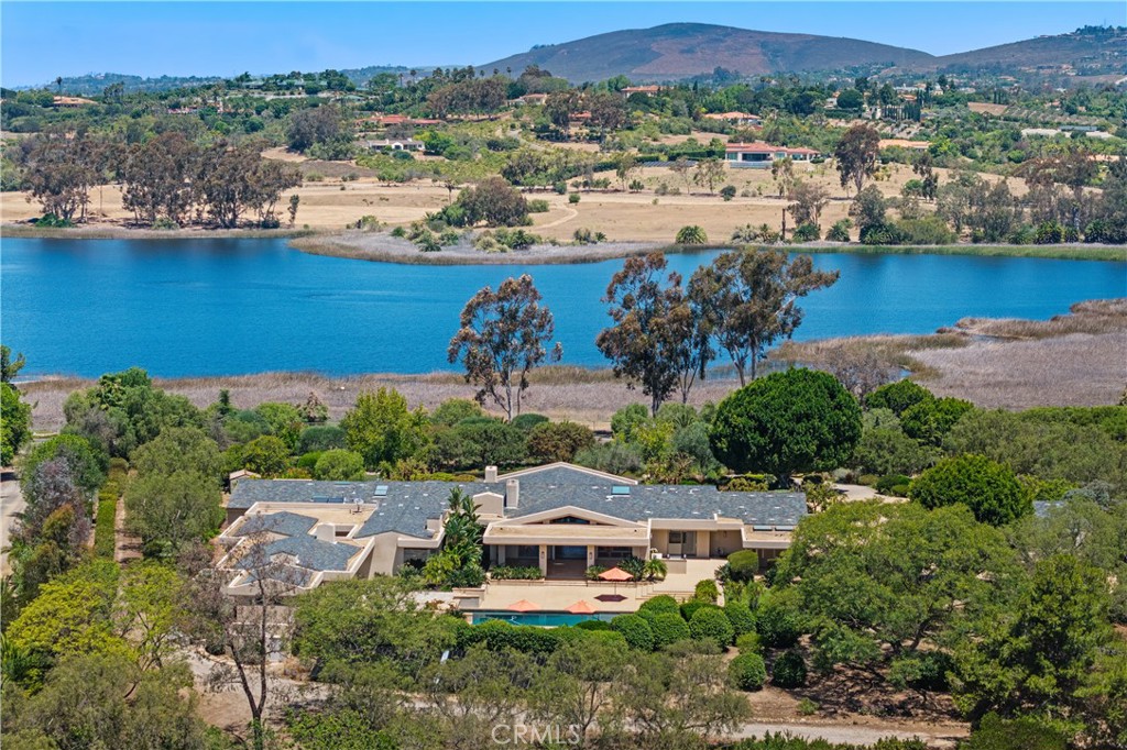 an aerial view of a house with a lake view