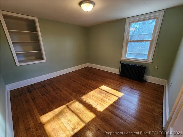 a view of a room with wooden floor and windows