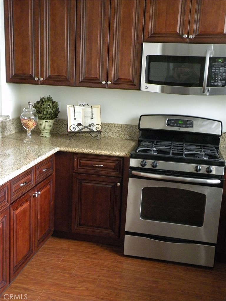 920 Central Avenue Riverside, CA 92507 - Photo 11 of 64 a kitchen with granite countertop wood cabinets and stainless steel appliances