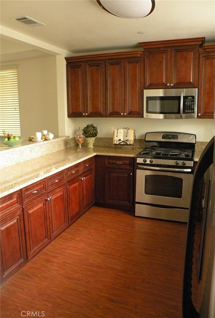 920 Central Avenue Riverside, CA 92507 - Photo 12 of 64 a kitchen with stainless steel appliances granite countertop a stove a sink dishwasher and a microwave