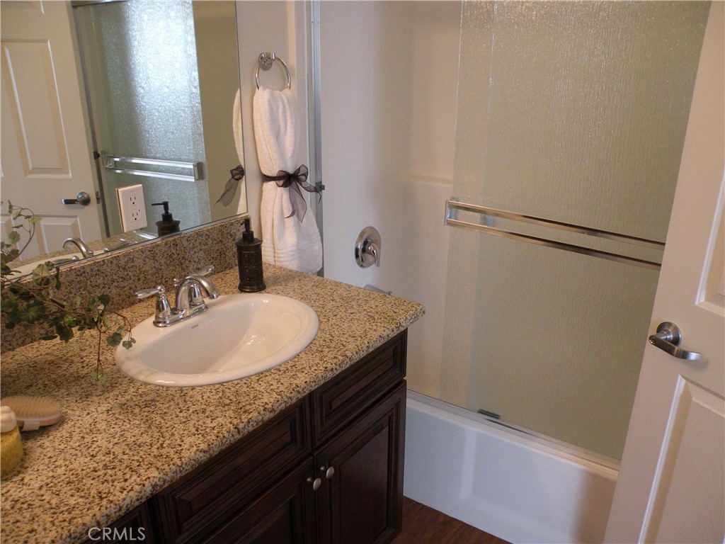 920 Central Avenue Riverside, CA 92507 - Photo 47 of 64 a bathroom with a granite countertop sink and a mirror