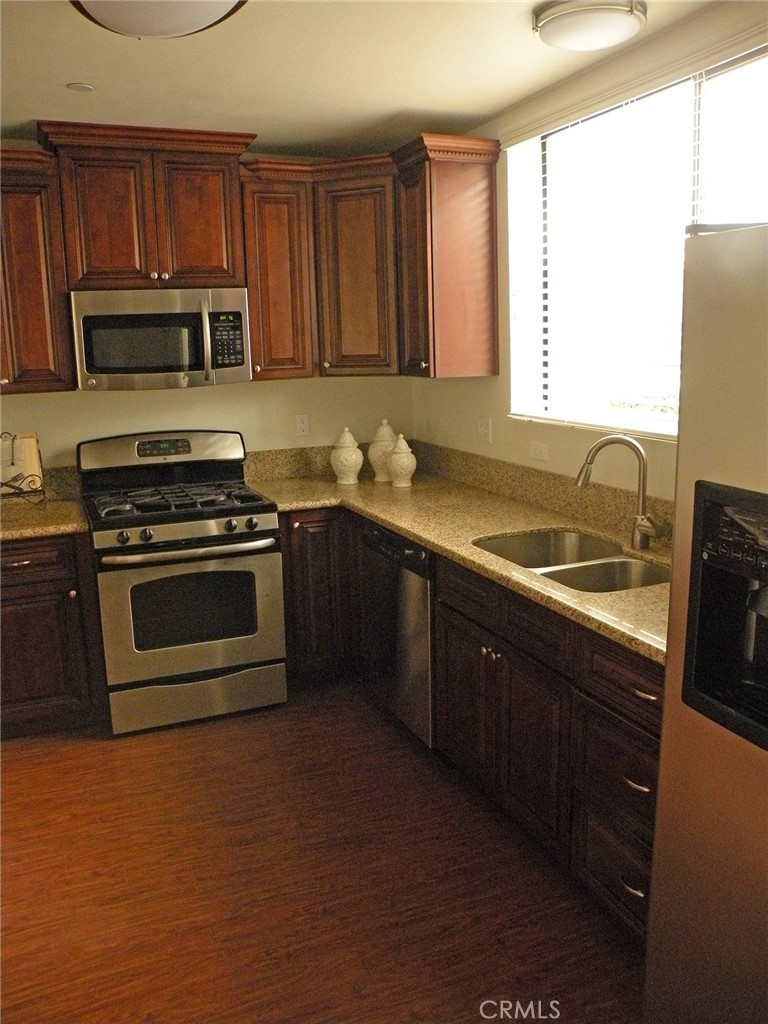 920 Central Avenue Riverside, CA 92507 - Photo 10 of 64 a kitchen with stainless steel appliances granite countertop a stove a sink and a microwave