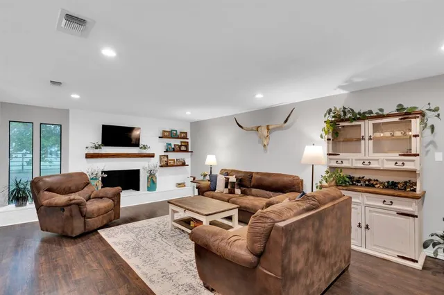 a living room with furniture flat screen tv and a fireplace