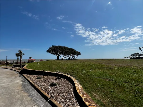a view of a water fountain and a big yard