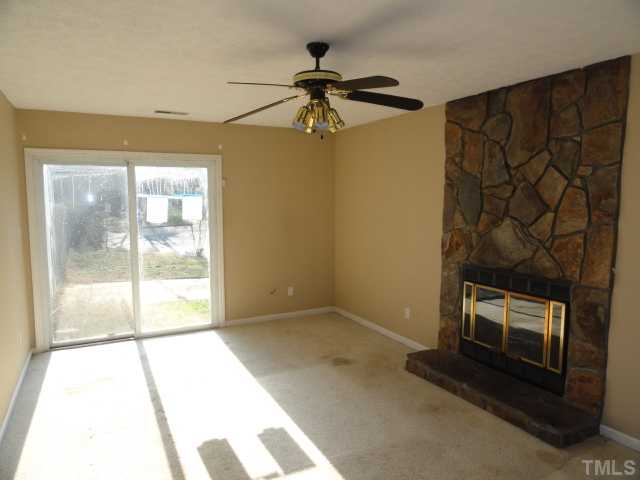 5101 Ranada Court Raleigh, NC 27616 - Photo 5 of 10 a view of an empty room with a fireplace and a window