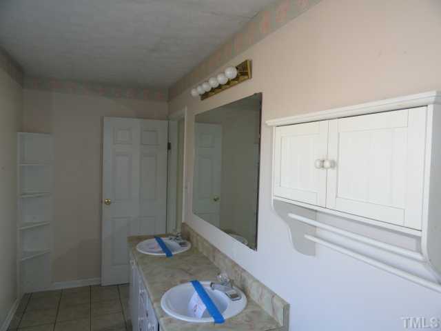 5101 Ranada Court Raleigh, NC 27616 - Photo 9 of 10 a bathroom with a granite countertop sink and a mirror
