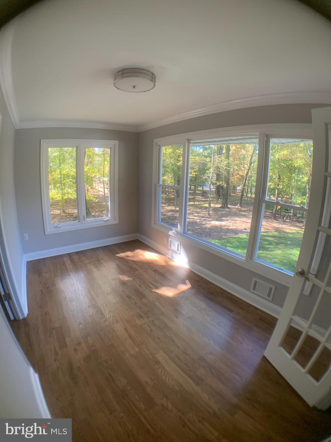 170 Old Georgetown Road Princeton, NJ 08540 - Photo 6 of 14 an empty room with wooden floor and windows