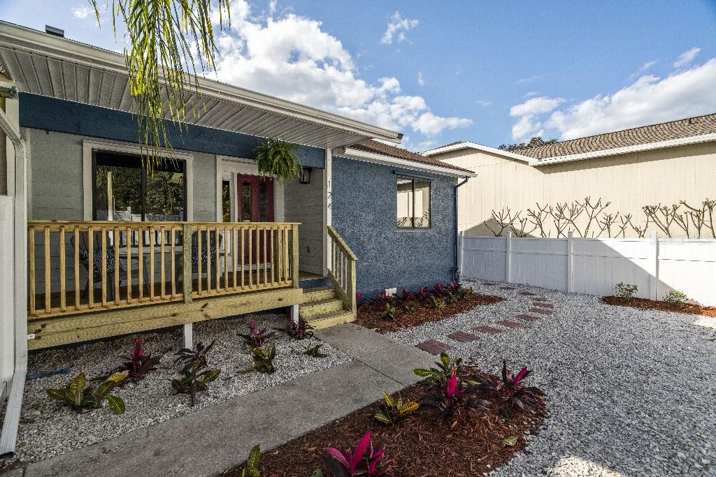 124 Anclote Road Tarpon Springs, FL 34689 - Photo 1 of 1 a view of a house with a small yard and wooden fence