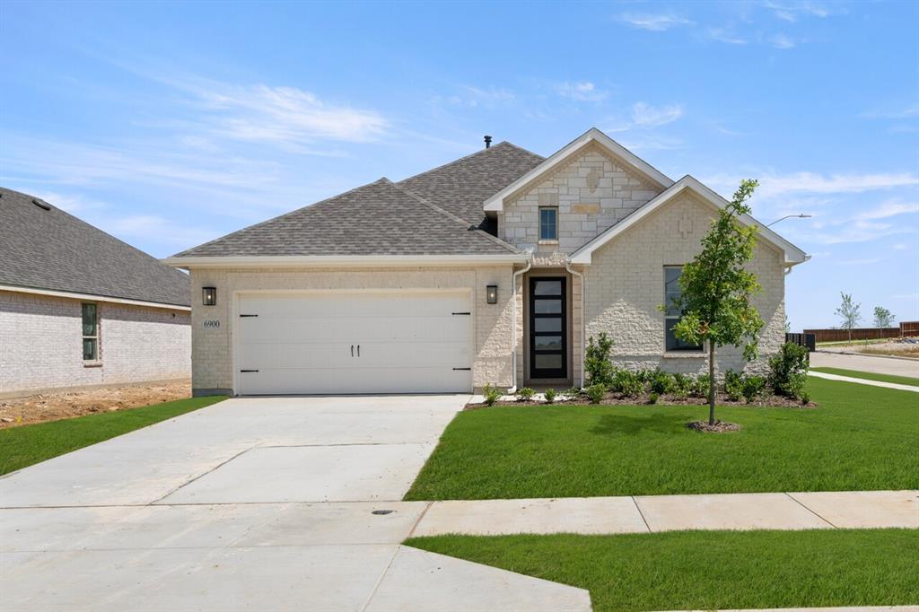 6928 Freight Train Lane Crowley, TX 76036 - Photo 1 of 1 a front view of a house with a yard and garage