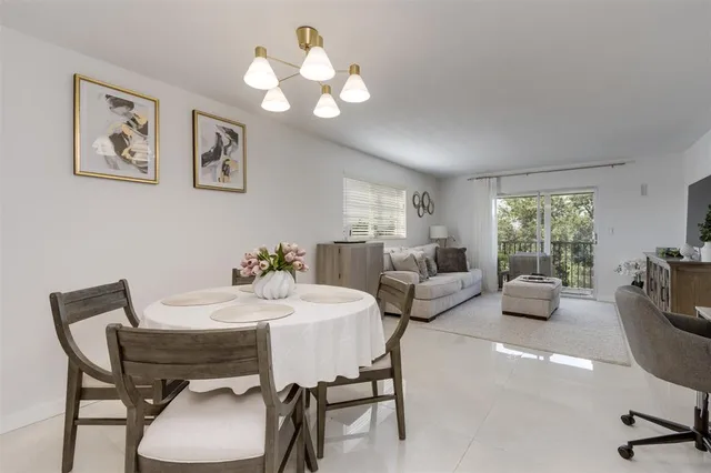a view of a dining room with furniture and a chandelier