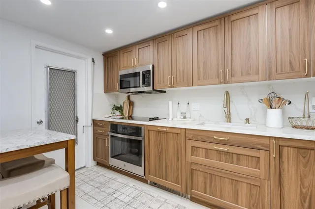 a kitchen with a sink stove and cabinets