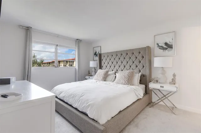 a room with a flat screen tv on dresser and a flat screen tv