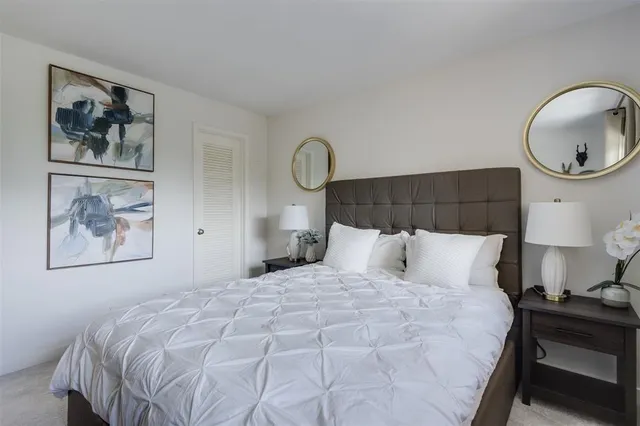 a bedroom with a flat screen tv and a bed