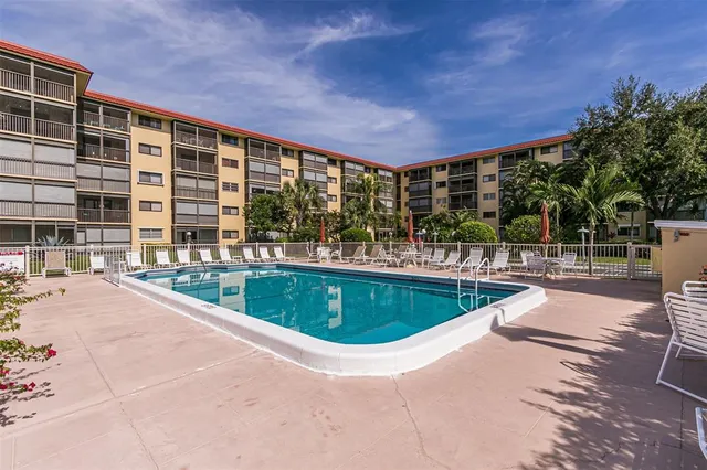 a front view of house with yard and swimming pool