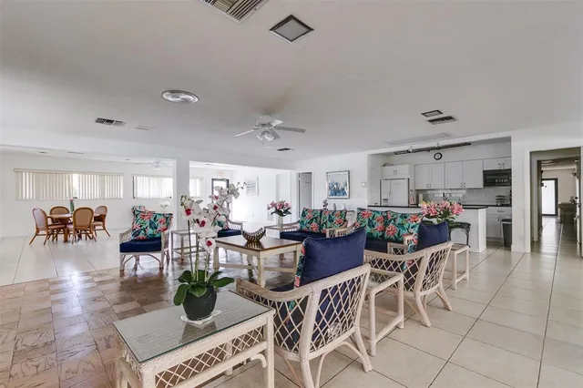 a kitchen with stainless steel appliances granite countertop a sink refrigerator and cabinets