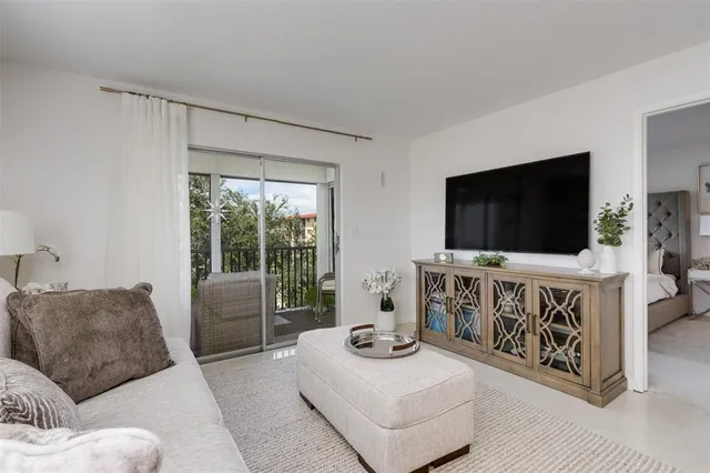 a dining room with furniture and a chandelier