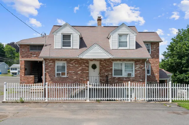a front view of a house with a fence