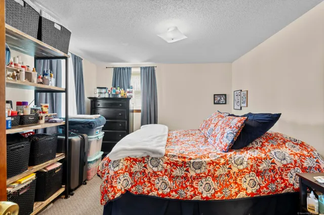 a bedroom with furniture and a book shelf