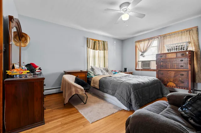 a bedroom with bed and flat screen tv