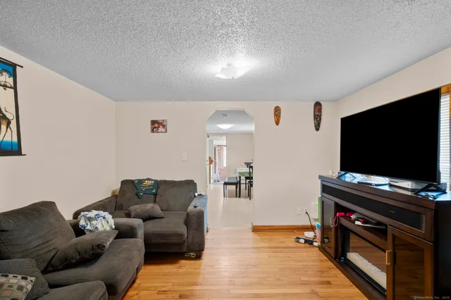 a bedroom with furniture and a two large window