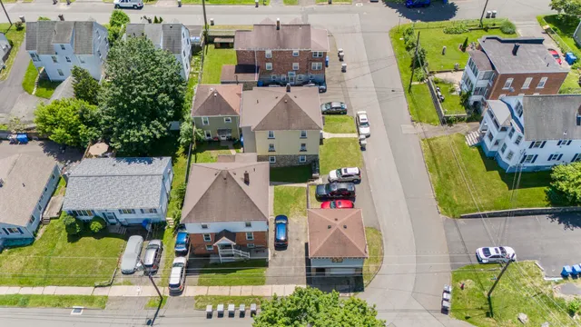 an aerial view of multiple houses with a yard