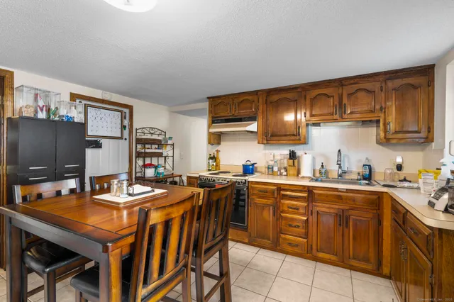 a kitchen with stainless steel appliances a stove a sink and a refrigerator