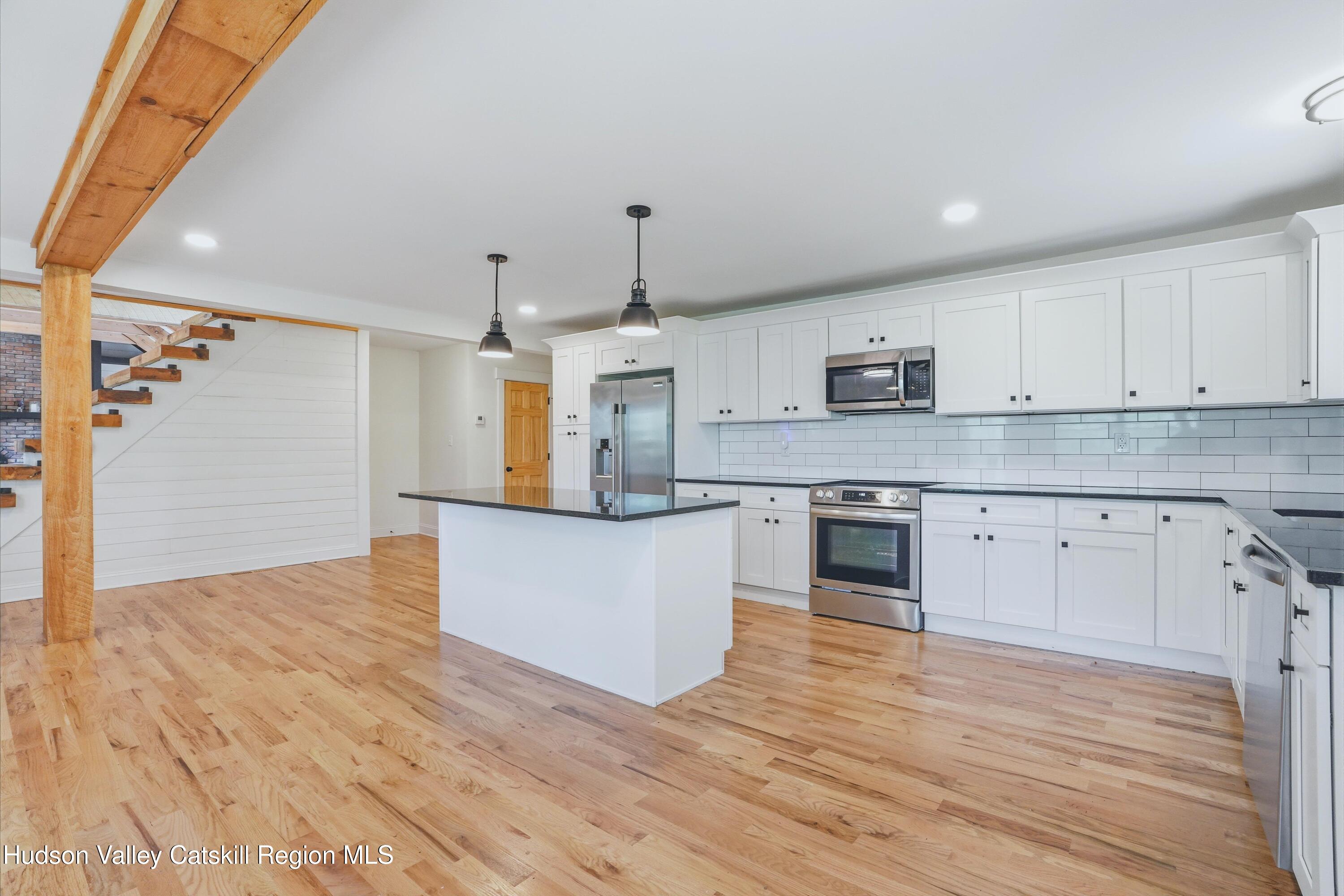 757 Taborton Road Sand Lake, NY 12153 - Photo 7 of 32 a kitchen with stainless steel appliances granite countertop a white stove top oven and white cabinets