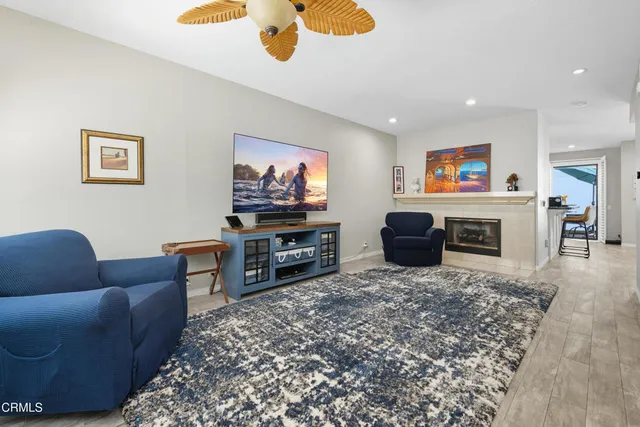 a kitchen with stainless steel appliances kitchen island granite countertop a refrigerator and a stove top oven