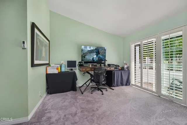 a bathroom with a tub a sink and glass door