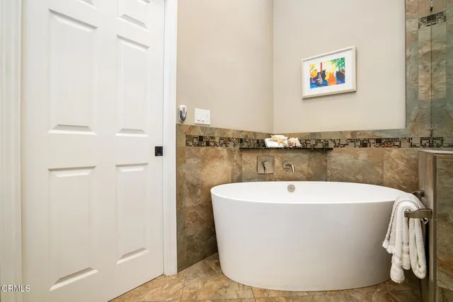 a bathroom with a bathtub and toilet