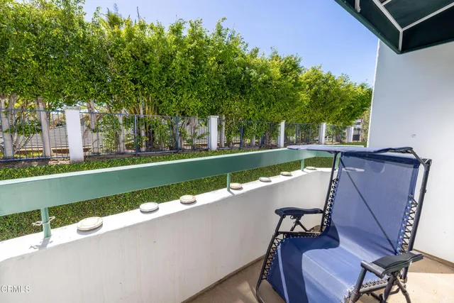 a large bed sitting in a bedroom next to a yellow cabinet