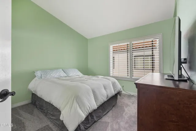 a bathroom with a granite countertop sink toilet a mirror and shower