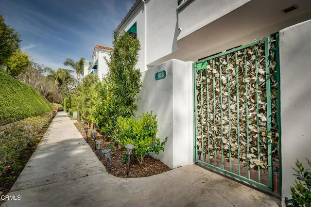 a couple of flower plants in front of door