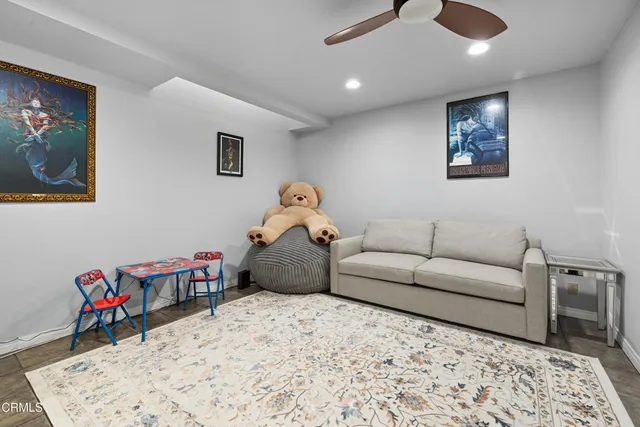 a bathroom with a granite countertop sink a toilet and a mirror