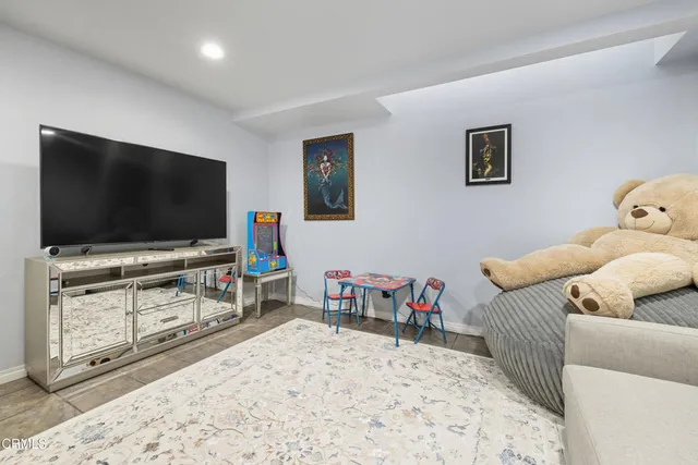 a front view of a house with a yard and potted plants