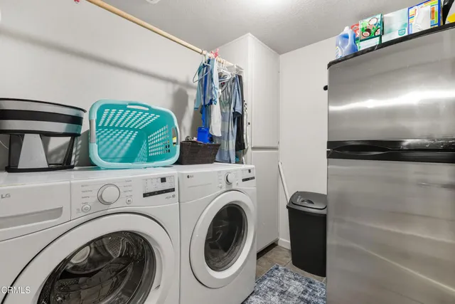an aerial view of residential houses with outdoor space and ocean view