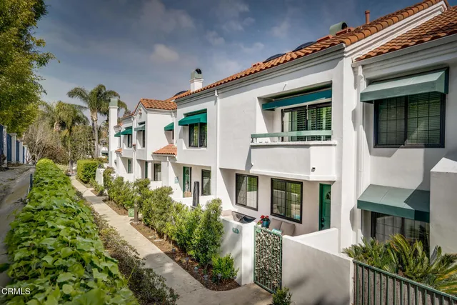a living room with a table and a potted plant