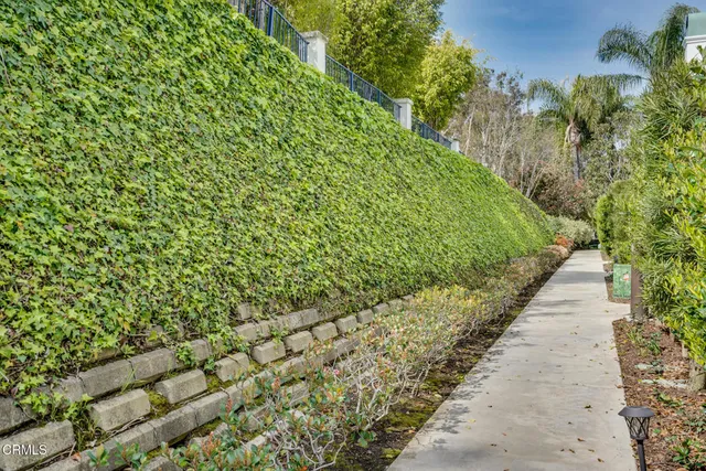 a balcony with table and chairs under an umbrella